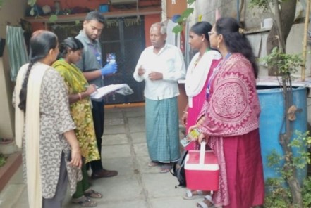 Photo showing, filling-in of household sample collection record at BJR Nagar